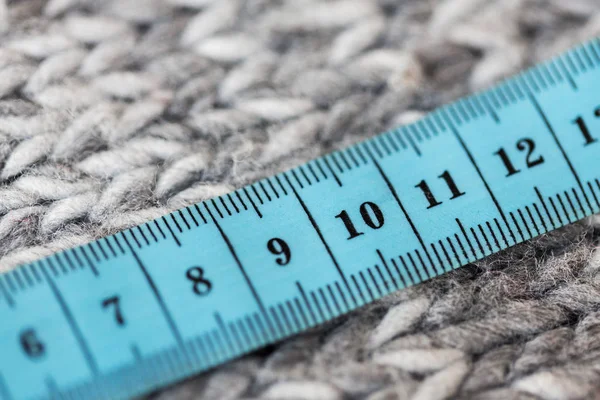 Close up of knitted item with measuring tape — Stock Photo, Image