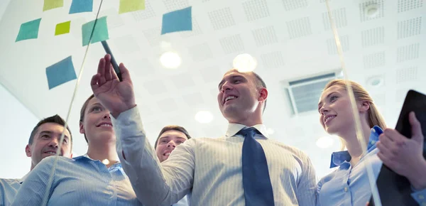 Smiling business people with marker and stickers — Stock Photo, Image