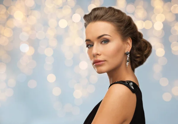 Woman in evening dress and earring — Stock Photo, Image