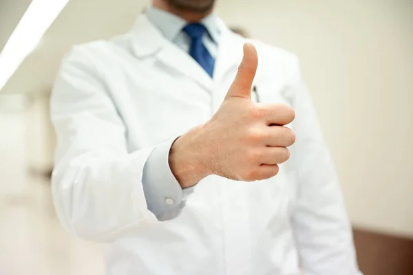 Close up of doctor at hospital showing thumbs — Stock Photo, Image