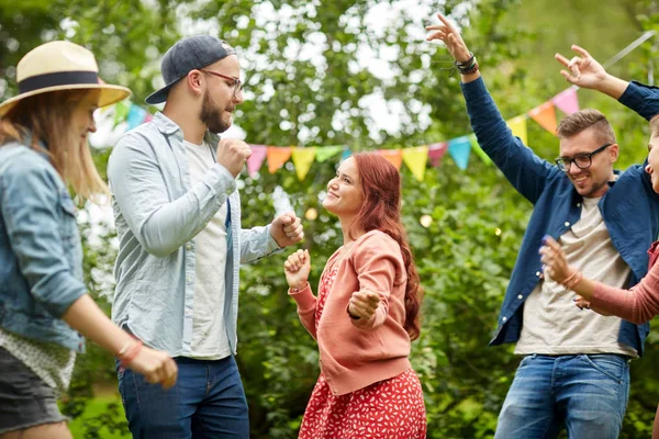 Счастливые друзья танцуют на летней вечеринке в саду — стоковое фото