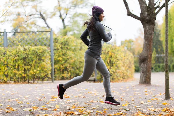 Nahaufnahme einer jungen Frau, die im Herbstpark läuft — Stockfoto