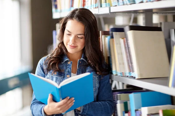 High school student girl reading book at library Stock Image