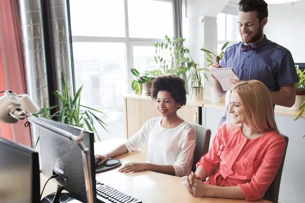 Happy creative team with computer in office — Stock Photo, Image