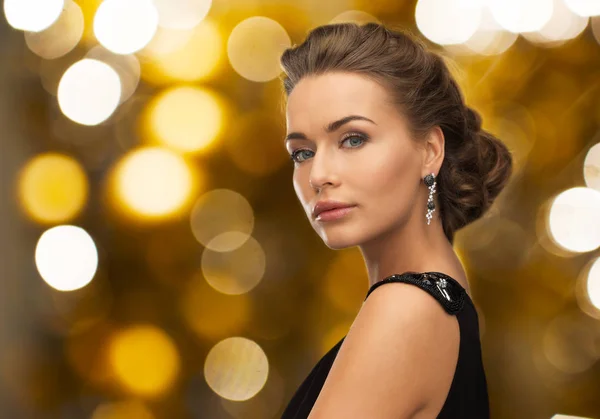 Woman in evening dress and earring — Stock Photo, Image