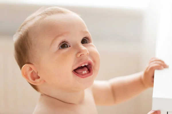 Happy little baby boy or girl at home looking up — Stock Photo, Image