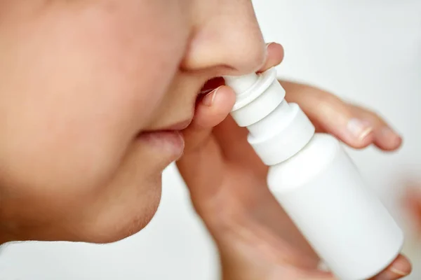 Primer plano de la mujer enferma usando aerosol nasal — Foto de Stock