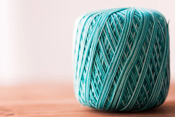 Ball of turquoise cotton yarn on wood — Stock Photo, Image
