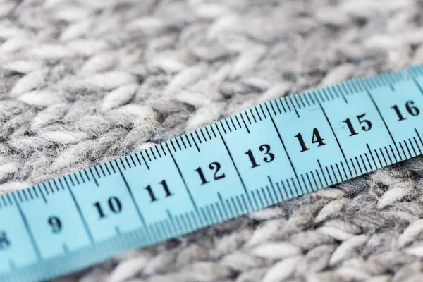 Close up of knitted item with measuring tape — Stock Photo, Image