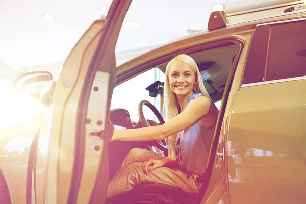 Mujer feliz dentro del coche en auto show o salón —  Fotos de Stock