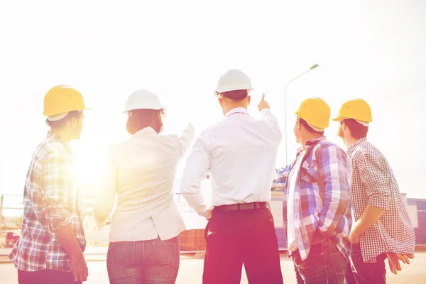 Group of builders and architects at building site — Stock Photo, Image