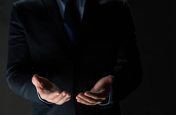 Close up of businessman holding something in hands — Stock Photo, Image