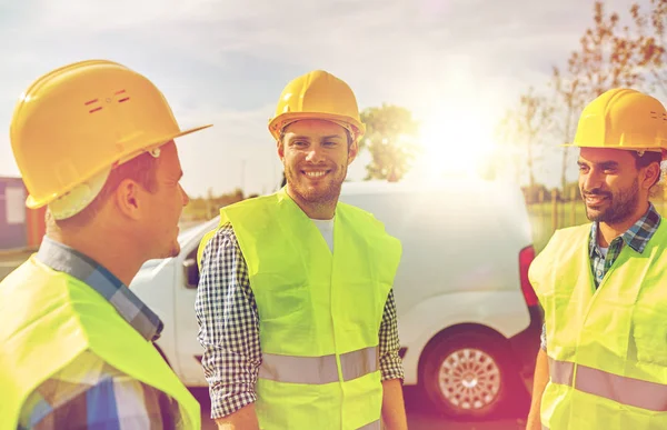 Happy male builders in high visible vests outdoors — Stock Photo, Image