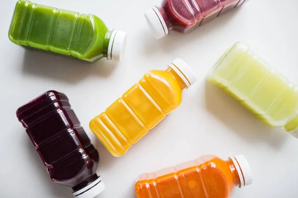 Bottles with different fruit or vegetable juices — Stock Photo, Image