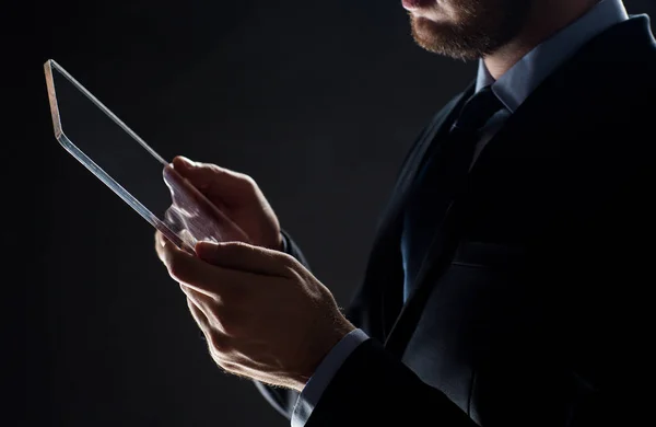 Close up of businessman with transparent tablet pc — Stock Photo, Image