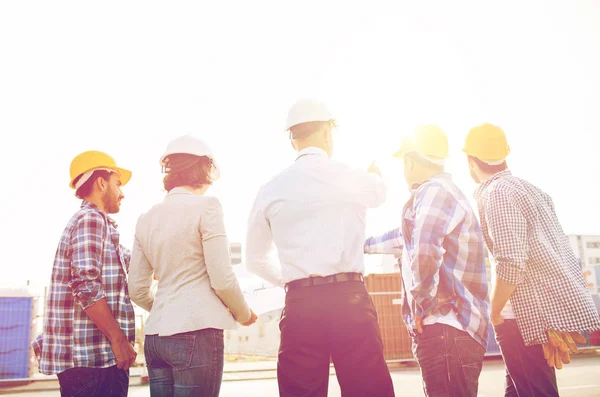 Group of builders and architects at building site — Stock Photo, Image