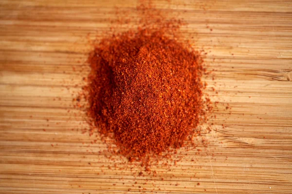 Cayenne pepper or paprika powder on wood — Stock Photo, Image