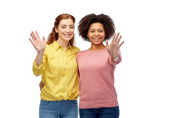 Happy smiling women waving hands over white — Stock Photo, Image