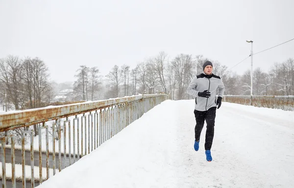 Άνθρωπος που τρέχει κατά μήκος χιόνι καλύπτονται χειμώνα γέφυρα δρόμο — Φωτογραφία Αρχείου