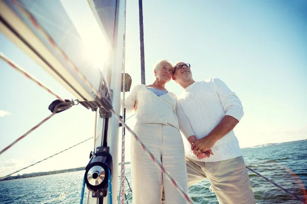 Senior couple hugging on sail boat or yacht in sea — Stock Photo, Image