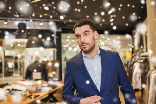 Young handsome man in jacket at clothing store — Stock Photo, Image