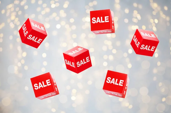 Boxes with sale signs over holidays lights — Stock Photo, Image
