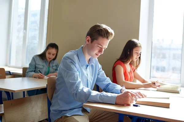 Group of students with books writing school test — Stock Photo, Image
