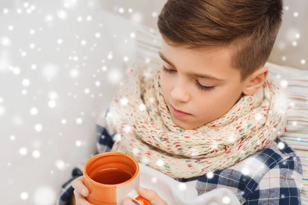 Close up of ill boy with flu drinking tea at home — Stock Photo, Image