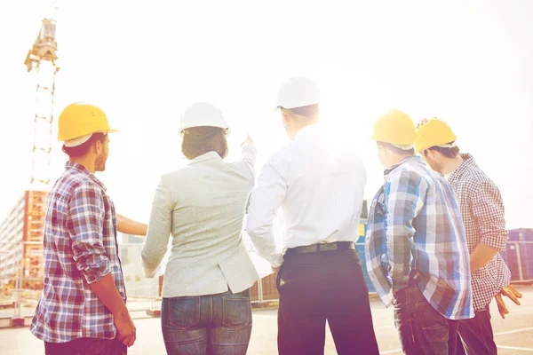 Group of builders and architects at building site — Stock Photo, Image