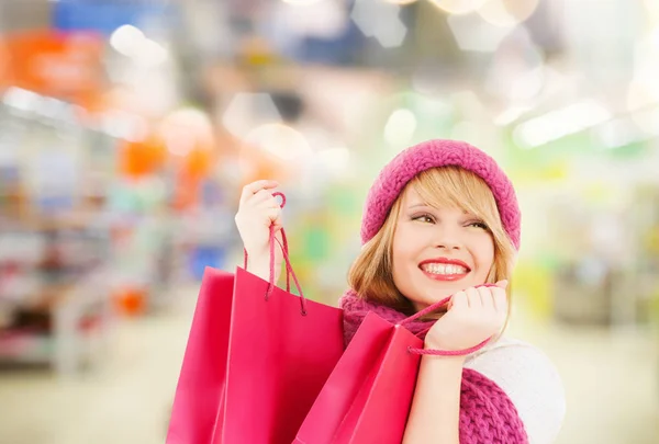 Woman in hat and scarf shopping at supermarket — Stock Photo, Image