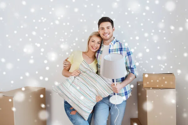 Happy couple with stuff moving to new home — Stock Photo, Image