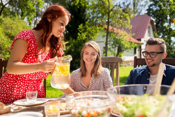 Glückliche Freunde beim Abendessen bei sommerlicher Gartenparty — Stockfoto