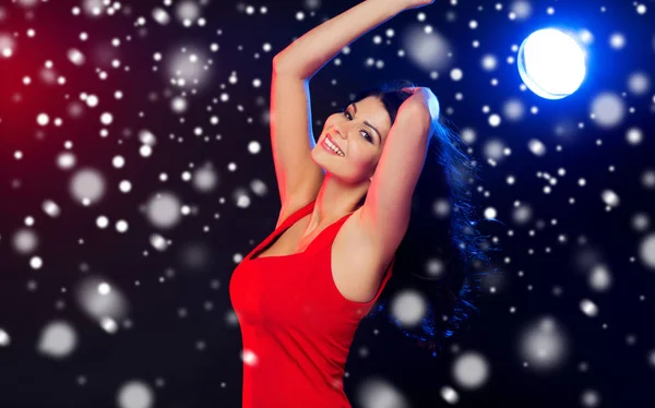 Beautiful sexy woman in red dancing at nightclub — Stock Photo, Image