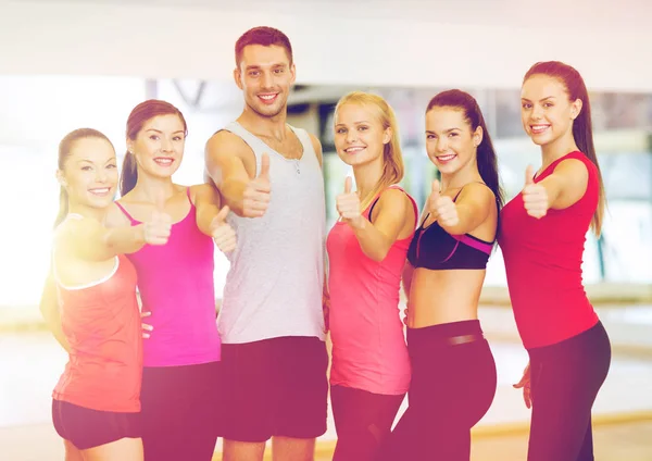 Group of people in the gym showing thumbs up — Stock Photo, Image