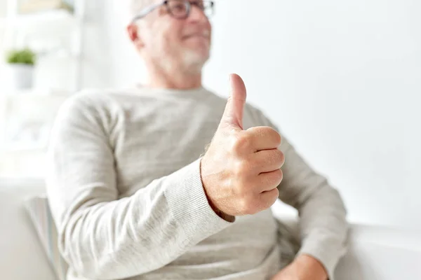 senior man showing thumbs up