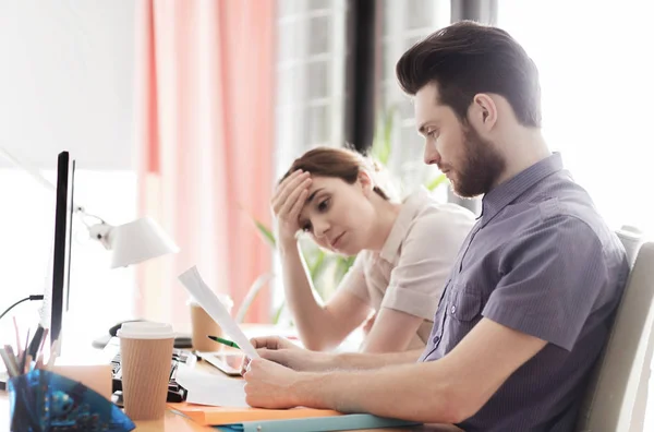 Creative team with reading paper in office — Stock Photo, Image