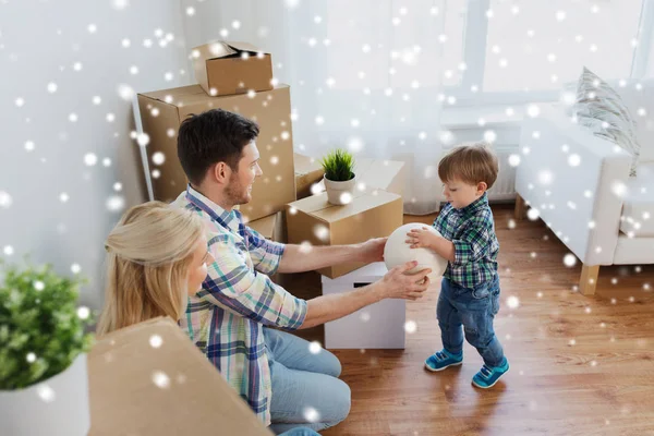 Happy family moving to new home and playing ball — Stock Photo, Image