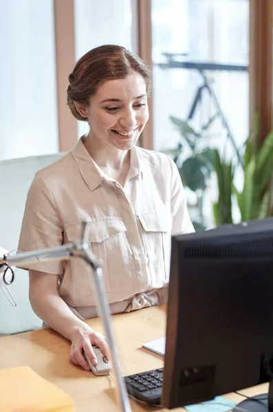 Счастливая деловая женщина с компьютером в офисе — стоковое фото