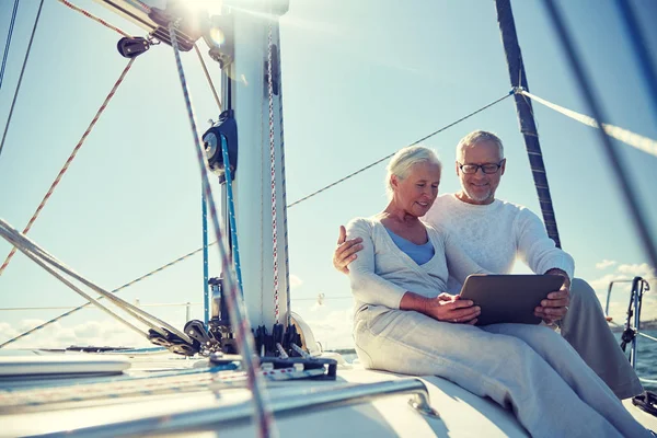 stock image senior couple with tablet pc on sail boat or yacht