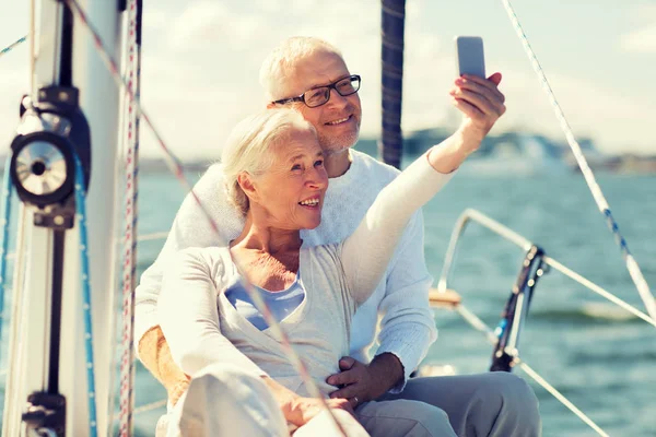 Senior couple taking selfie on sail boat or yacht — Stock Photo, Image