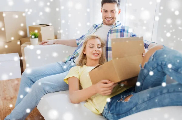 Happy couple with big cardboard boxes at new home — Stock Photo, Image