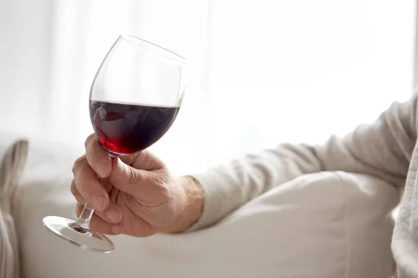 Close up of hand holding glass with red wine — Stock Photo, Image