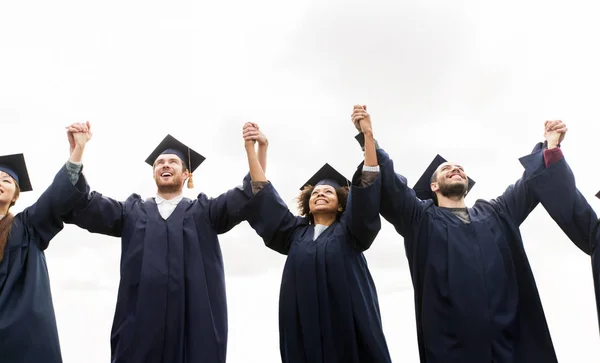 Happy students or bachelors celebrating graduation — Stock Photo, Image