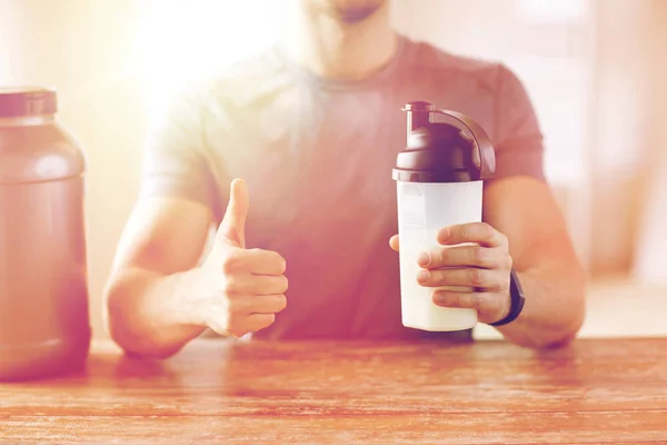 Man with protein shake bottle showing thumbs up — Stock Photo, Image