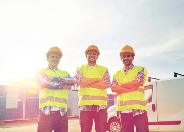 Happy male builders in high visible vests outdoors — Stock Photo, Image