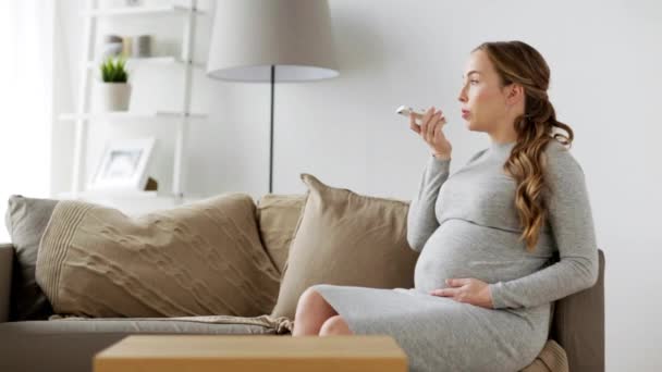 Pregnant woman using voice recorder on smartphone — Stock Video