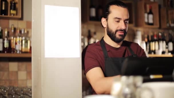 Happy man or waiter at cashbox in coffee shop — Stock Video