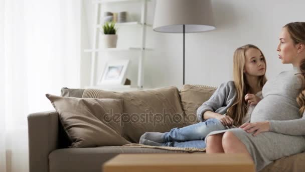 Happy pregnant woman and girl on sofa at home — Stock Video