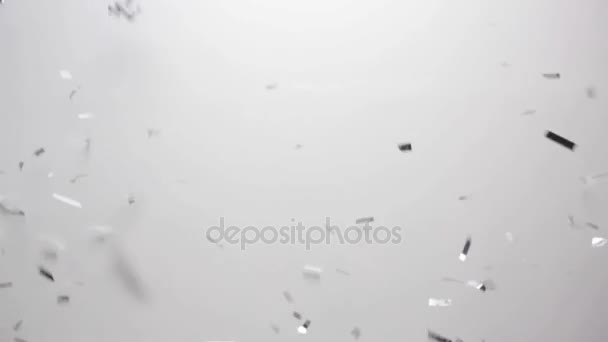 Silver confetti falling over white background — Stock Video