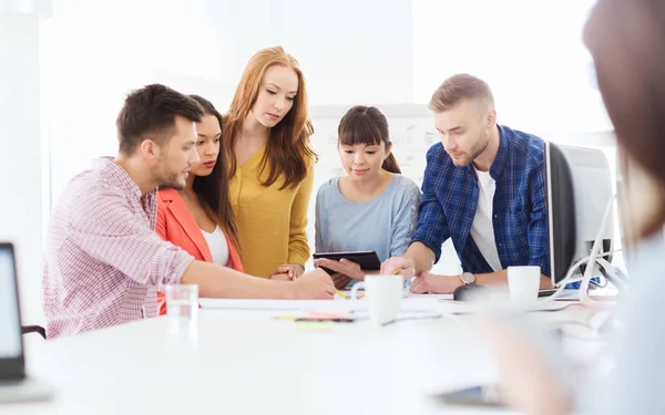 Kreativ-Team mit Papieren und Tablet-PC im Büro — Stockfoto